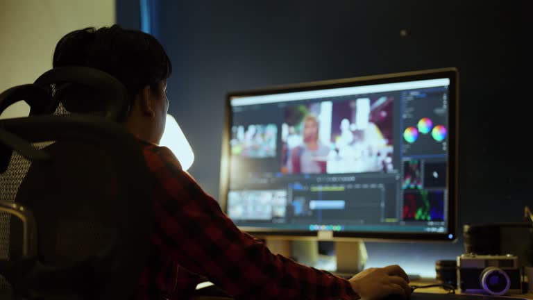 Male Videographer Edits and Cuts Footage